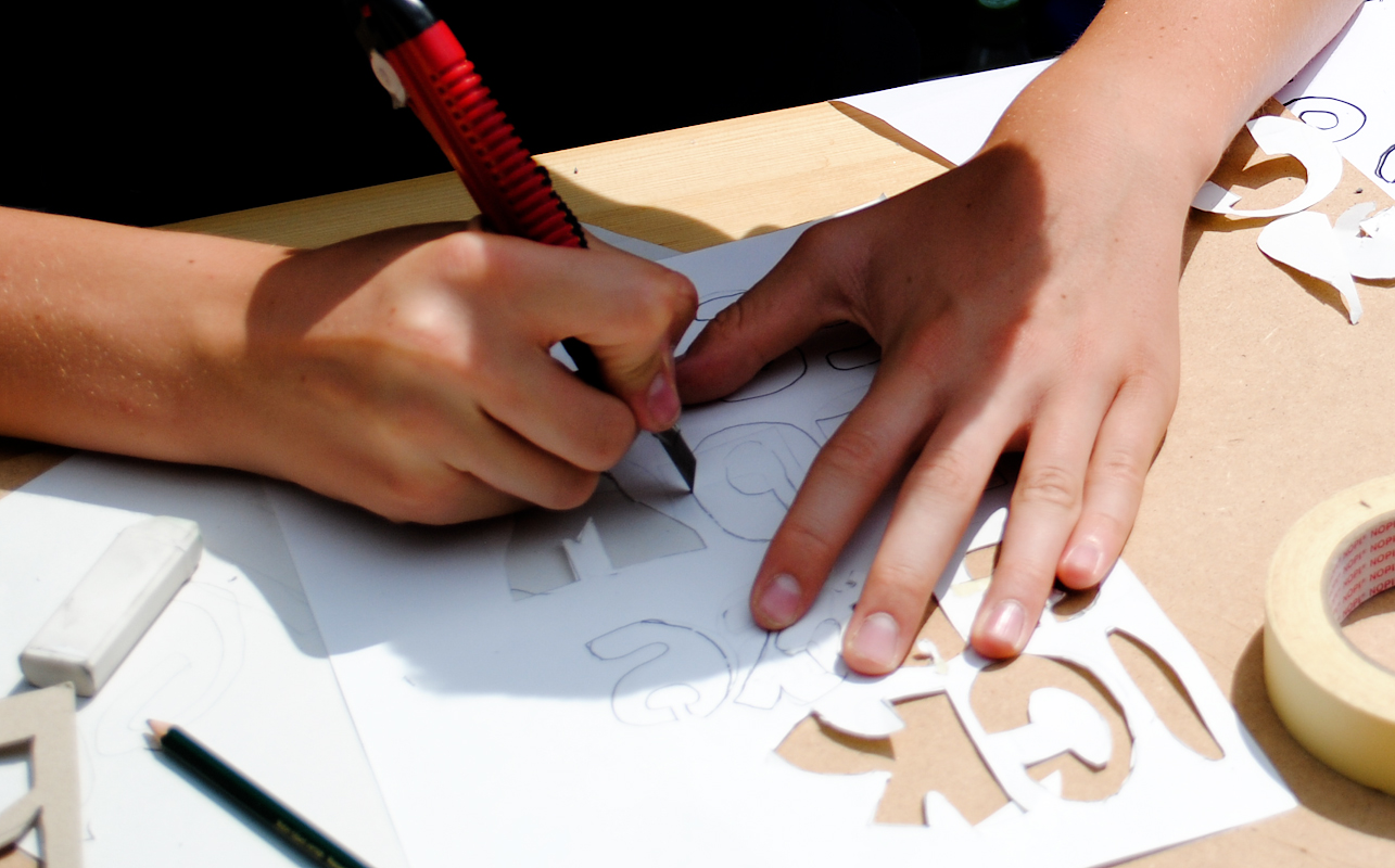 Young people design stencils in a workshop