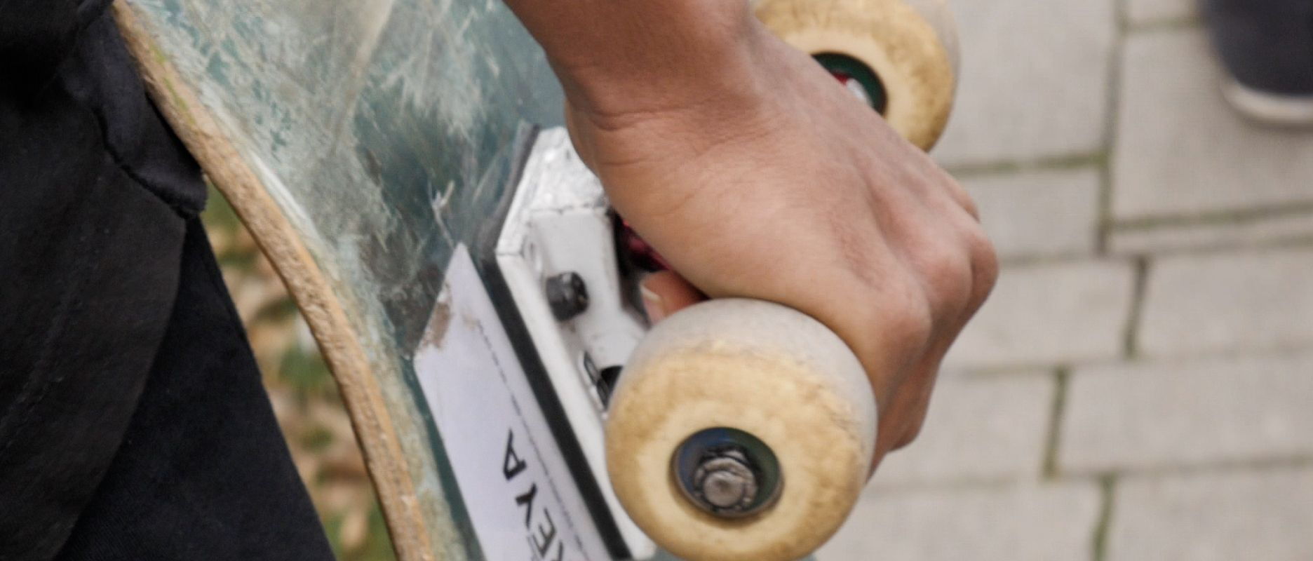 Person carrying a skateboard